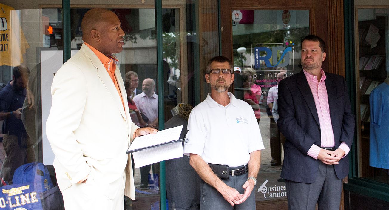 Vice Mayor Alonzo Jones, left, River District Printing owner David Hobson, center, and Maddyzack Des