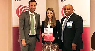 Corrie Teague Bobe (center), and Telly Tucker (right) receive award.