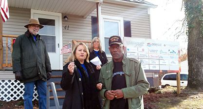 Charles Duke receives key to house during ceremony