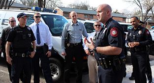 Police Chief Scott Booth speaks to officers before Thursday's first community walk. 