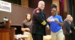 Police Chief Scott Booth and graduating student Anita White