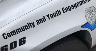 Police car with Community and Youth Engagement logo