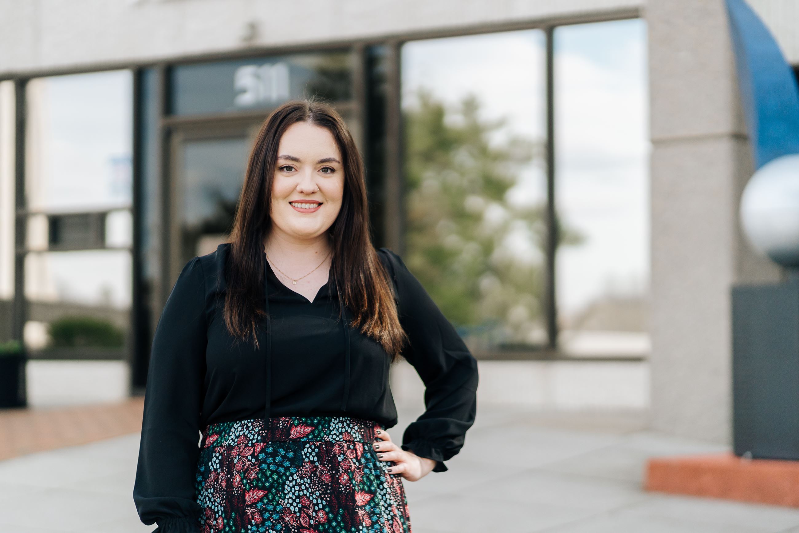 Chrislyn Gardner standing in front of Ruby B. Archie Library