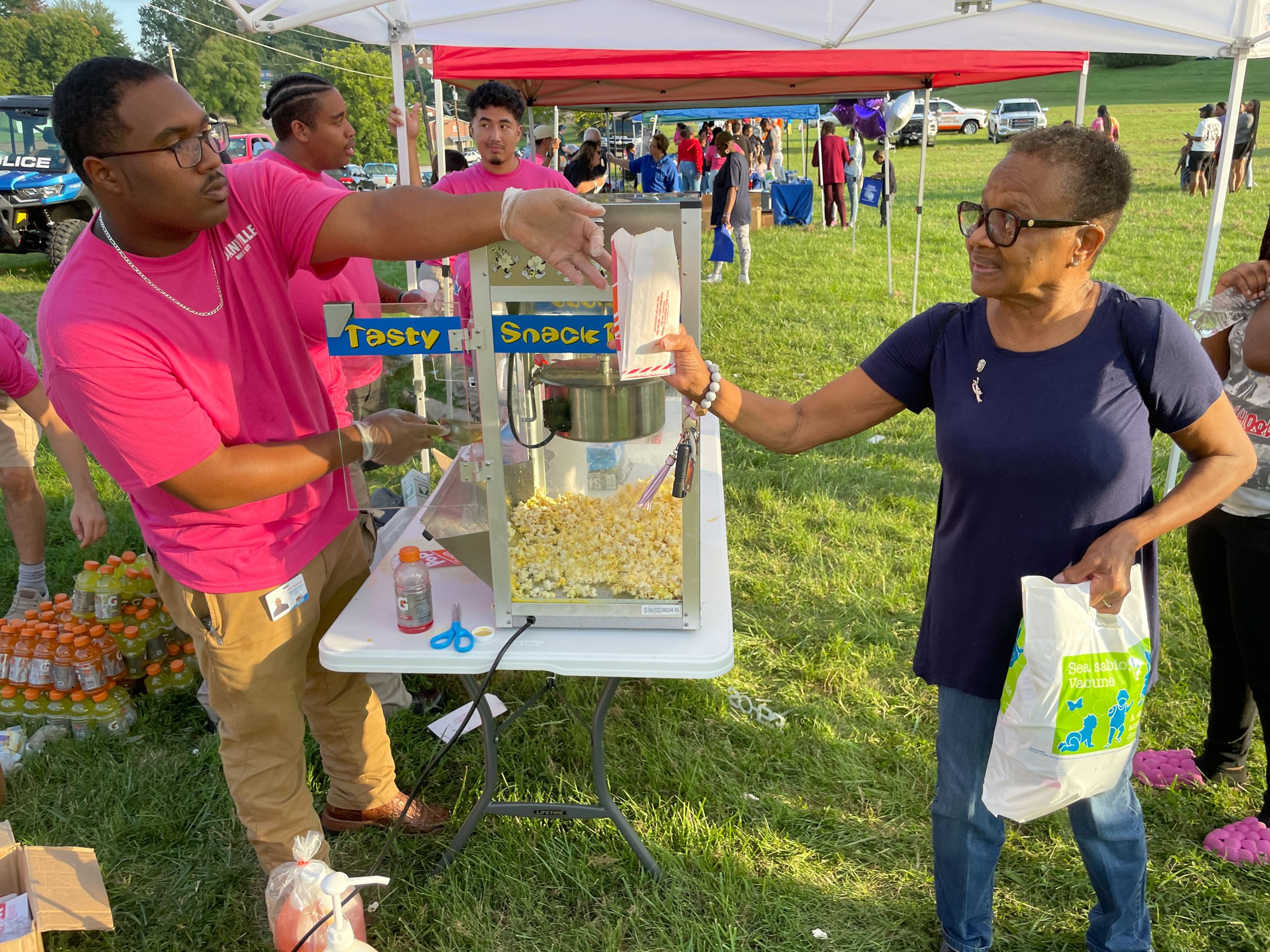 CES Ford serves popcorn during 2023 National Night Out.
