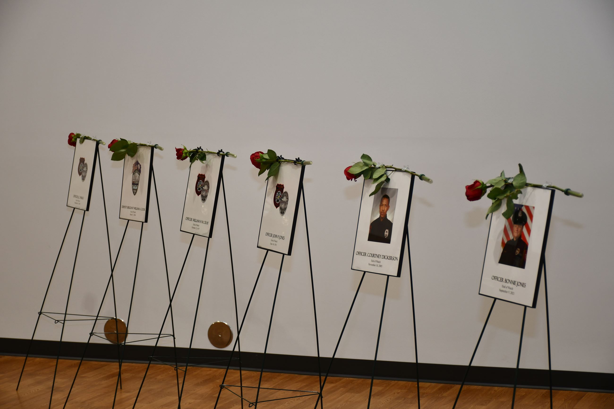 Roses placed on images of fallen officers.