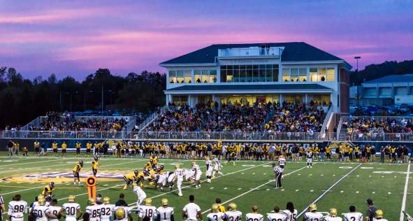 Football game at night with a full crowd