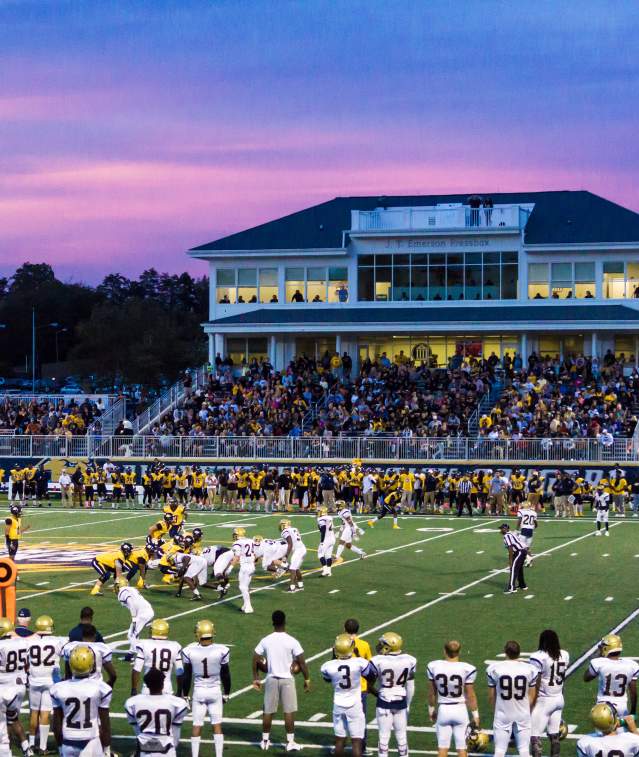 Football game at night with a full crowd